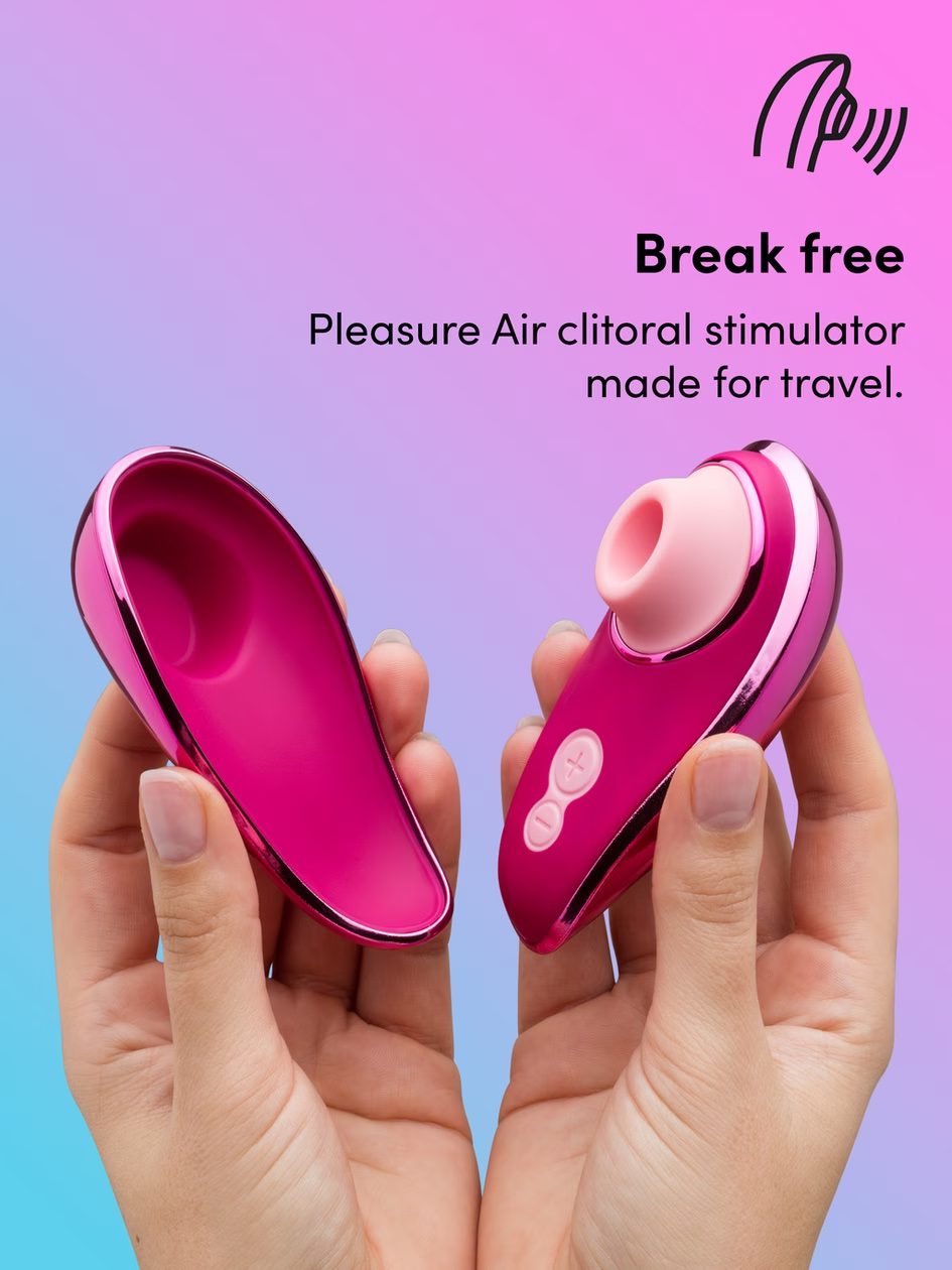 The bright pink vibrator with its cover being held up by hands.